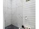 Modern shower featuring marble-look tile and white shiplap walls at 925 Hamilton Rd, Chester, SC 29706