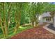 Private backyard featuring a fire pit and lush, wooded surroundings and a beautiful lawn at 9520 Squirrel Hollow Ln, Charlotte, NC 28270