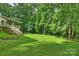 This is a lush backyard with an inviting outdoor space, perfect for relaxation and enjoying nature at 9520 Squirrel Hollow Ln, Charlotte, NC 28270