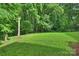 This is a lush backyard with an inviting outdoor space, perfect for relaxation and enjoying nature at 9520 Squirrel Hollow Ln, Charlotte, NC 28270