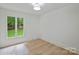 Bright bedroom with hardwood floors and windows offering natural light and greenery views at 9520 Squirrel Hollow Ln, Charlotte, NC 28270