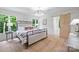 Charming bedroom boasts light wood floors, neutral walls, and modern lighting at 9520 Squirrel Hollow Ln, Charlotte, NC 28270