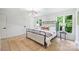 Charming bedroom boasts light wood floors, neutral walls, and bright windows at 9520 Squirrel Hollow Ln, Charlotte, NC 28270