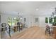 Bright and spacious dining room with wood floors, modern lighting, and views of the outdoors at 9520 Squirrel Hollow Ln, Charlotte, NC 28270