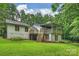This home features a well-maintained exterior with a spacious deck overlooking a beautiful lawn at 9520 Squirrel Hollow Ln, Charlotte, NC 28270