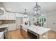 Bright and modern kitchen with a large island, custom cabinets, and open layout to dining room at 9520 Squirrel Hollow Ln, Charlotte, NC 28270