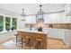 Bright kitchen featuring a large island, modern appliances, and custom lighting at 9520 Squirrel Hollow Ln, Charlotte, NC 28270