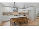 Bright kitchen featuring a large island, modern appliances, and custom lighting at 9520 Squirrel Hollow Ln, Charlotte, NC 28270