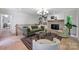 Living room features hardwood floors, fireplace, built-ins, and modern decor at 9520 Squirrel Hollow Ln, Charlotte, NC 28270