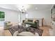 Living room boasts hardwood floors, modern decor, and plenty of natural light at 9520 Squirrel Hollow Ln, Charlotte, NC 28270
