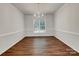 Dining room with hardwood floors, modern lighting, and a large window at 10319 Willingham Rd, Huntersville, NC 28078