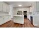 Bright, all-white kitchen featuring stainless steel appliances, an island, and subway tile backsplash at 10319 Willingham Rd, Huntersville, NC 28078