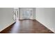Bright living room featuring hardwood floors, large windows, and staircase access at 10319 Willingham Rd, Huntersville, NC 28078