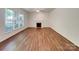Spacious living room with hardwood floors and a fireplace, offering a cozy and inviting space at 10319 Willingham Rd, Huntersville, NC 28078