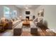 Bright living room with a fireplace, hardwood floors, and neutral furniture staging at 10319 Willingham Rd, Huntersville, NC 28078
