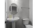 A bathroom featuring a white pedestal sink, toilet and a round mirror at 10327 Shelter Rock Ct, Charlotte, NC 28214