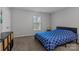 The bedroom features a double bed with blue patterned bedding, one window and neutral walls at 10327 Shelter Rock Ct, Charlotte, NC 28214