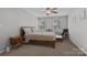 This bedroom features a neutral color scheme, ceiling fan, and two windows for ample natural light at 10327 Shelter Rock Ct, Charlotte, NC 28214