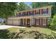 Charming two-story home with red shutters, vinyl siding, a covered porch and a two-car garage at 10327 Shelter Rock Ct, Charlotte, NC 28214