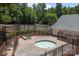 Relaxing community hot tub area with lounge chairs and a privacy fence at 10327 Shelter Rock Ct, Charlotte, NC 28214