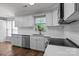 A kitchen featuring white cabinets, stainless steel appliances, and wood flooring at 10327 Shelter Rock Ct, Charlotte, NC 28214