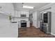 A kitchen featuring white cabinets, stainless steel appliances, and wood flooring at 10327 Shelter Rock Ct, Charlotte, NC 28214