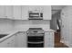 A kitchen with white cabinets, stainless steel appliances and white subway tile at 10327 Shelter Rock Ct, Charlotte, NC 28214