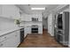 Well-lit kitchen featuring modern appliances, white cabinets, and sleek countertops at 10327 Shelter Rock Ct, Charlotte, NC 28214