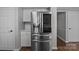 A stainless steel refrigerator stands alongside white cabinets and subway tile at 10327 Shelter Rock Ct, Charlotte, NC 28214