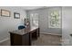 Home office featuring a large desk, natural light, and neutral decor at 10327 Shelter Rock Ct, Charlotte, NC 28214