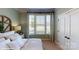 Bedroom featuring a large window with patterned curtains, neutral walls, and a queen bed at 106 Noah Ln, Troutman, NC 28166