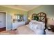 Bedroom features an upholstered bed with white linens, decorative mirror, and natural lighting at 106 Noah Ln, Troutman, NC 28166