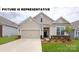Charming single-story home features a well-manicured lawn, two-car garage, and inviting front porch at 106 Noah Ln, Troutman, NC 28166