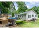 Landscaped backyard with pool, deck, and mature trees at 107 Oakland Rd, Belmont, NC 28012