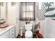 Bright bathroom with updated toilet, sink, cabinet, and modern shower curtain at 107 Oakland Rd, Belmont, NC 28012