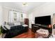 Cozy bedroom featuring wood floors, a ceiling fan, and ample natural lighting at 107 Oakland Rd, Belmont, NC 28012