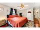 Comfortable bedroom with hardwood floors, ceiling fan, warm lighting, and modern decor at 107 Oakland Rd, Belmont, NC 28012