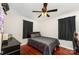 Cozy bedroom featuring wood floors, a ceiling fan, and neutral wall paint at 107 Oakland Rd, Belmont, NC 28012