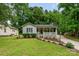 Charming single-story home features a welcoming front porch, well-maintained lawn, and beautiful landscaping at 107 Oakland Rd, Belmont, NC 28012