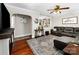 Inviting living room with open archway and views into the kitchen, with warm wood floors at 107 Oakland Rd, Belmont, NC 28012