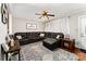 Cozy living room with dark brown leather seating, ceiling fan, and decorative accents at 107 Oakland Rd, Belmont, NC 28012