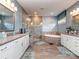 A spacious bathroom featuring double sinks, a glass enclosed shower, and a soaking tub at 114 Reserve Ln, Fort Mill, SC 29707