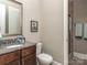 Clean bathroom featuring a granite vanity, a framed mirror, and a tiled walk-in shower at 114 Reserve Ln, Fort Mill, SC 29707