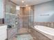 A tiled walk-in shower and soaking tub are the focal point in this relaxing bathroom at 114 Reserve Ln, Fort Mill, SC 29707
