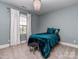 This bedroom features a chandelier, a comfortable bed, and lots of natural light at 114 Reserve Ln, Fort Mill, SC 29707