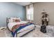 A cozy bedroom with patterned walls, a comfortable bed, and a sunny window at 114 Reserve Ln, Fort Mill, SC 29707