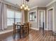 Inviting dining room featuring wood floors, natural light, and a modern light fixture at 114 Reserve Ln, Fort Mill, SC 29707