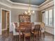 Dining room with chandelier, stylish chairs, and white trim at 114 Reserve Ln, Fort Mill, SC 29707