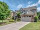 Lovely home boasts a two car garage and a concrete driveway with beautiful landscaping at 114 Reserve Ln, Fort Mill, SC 29707