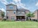 View of the backyard, patio, fire pit, and the exterior of the house at 114 Reserve Ln, Fort Mill, SC 29707